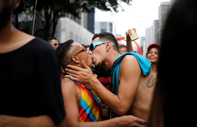 Revellers kiss in the annual Gay Pride parade along Paulista Avenue in Sao Paulo, Brazil, May 29, 2016. (Photo by Nacho Doce/Reuters)