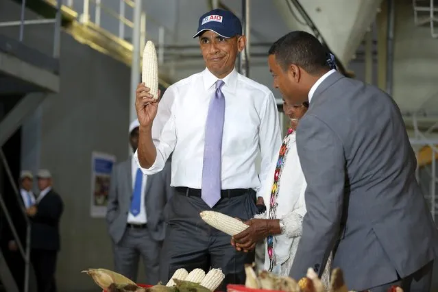 U.S. President Barack Obama (L) shows off a ear of corn grown by a farmer (2nd R) participating in the Feed the Future program as he tours the Faffa Food factory in Addis Ababa, Ethiopia July 28, 2015. Obama told Ethiopia's leaders on Monday that allowing more political freedoms would strengthen the African nation, which had already lifted millions out of a poverty once rooted in recurring famine. (Photo by Jonathan Ernst/Reuters)