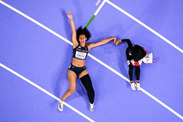 An overview shows Silver medallist Indonesia's Karisma Tiarani (R) and Bronze medallist Britain's Ndidikama Okoh reacting after the women's 100m T63 final during the Paris 2024 Paralympic Games at the Stade de France, in Saint-Denis, outside Paris on September 7, 2024. (Photo by François-Xavier Marit/AFP Photo)