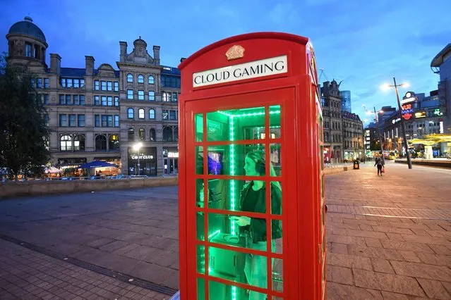 The tech company Nvidia has installed a temporary mini-gaming arcade in a phone box in Exchange Square, Manchester, United Kingdom on October 30, 2021, using a 5G connection, a tablet and a gamepad. (Photo by Anthony Devlin/PA Wire Press Association)