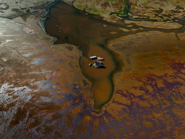 Boats are seen stranded in Aleixo Lake due to the severe drought in the west of Manaus, Amazonas State, Brazil, on September 20, 2024. (Photo by Michael Dantas/AFP Photo)