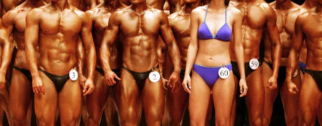 A female competitor (4th R) of the “Post-secondary College Body Fitness” category stands on the stage with other male competitors during the Hong Kong Bodybuilding Championship in Hong Kong June 11, 2006. (Photo by Paul Yeung/Reuters)