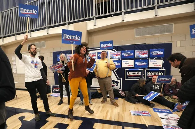 Supporters of Democratic presidential candidate Senator Bernie Sanders hold signs at a caucus in Des Moines, Iowa, U.S. February 3, 2020. (Photo by Brian Snyder/Reuters)