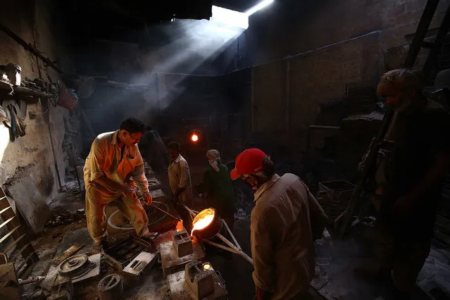 A Pakistani laborer works at a factory that produces iron hammers in Karachi, Pakistan, 31 May 2022. The govermant ordered strict action against hoarders and profiteers to control the rising inflation that has affected the poor masses at large. (Photo by Shahzaib Akber/EPA/EFE)
