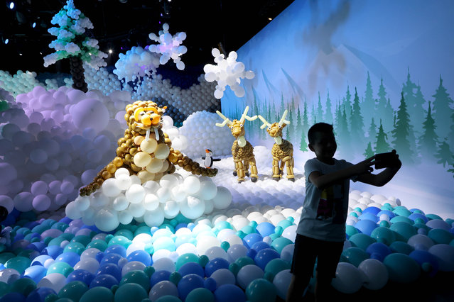 A visitor takes photos at the “Balloon Story” exhibition in Tel Aviv, Israel, on August 3, 2023. The eco-friendly “Balloon Story” exhibition attracts visitors with biodegradable balloons and inflatable art installations, highlighting the fusion of creativity and sustainability. (Photo by Xinhua News Agency/Rex Features/Shutterstock)