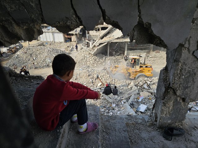 Palestinians try to clear the rubble on the ruins of buildings destroyed following Israeli attacks on Khan Yunis, Gaza on December 8, 2024. (Photo by Hani Alshaer/Anadolu via Getty Images)