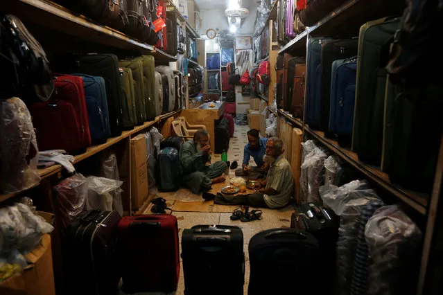Shop workers eat their iftar meal in a suitcase shop ahead of Eid al-Fitr in Karachi, Pakistan July 4, 2016. (Photo by Akhtar Soomro/Reuters)