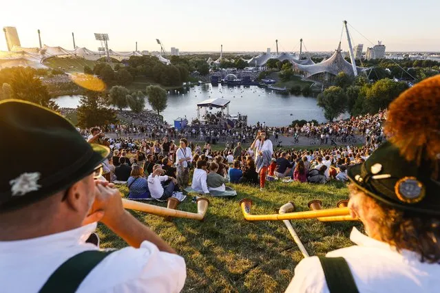 People attend the opening ceremony for the European Championships Munich 2022, Munich, Germany, 10 August 2022. The championships will feature nine Olympic sports, Athletics, Beach Volleyball, Canoe Sprint, Cycling, Artistic Gymnastics, Rowing, Sport Climbing, Table Tennis, and Triathlon. (Photo by Ronald Wittek/EPA/EFE)