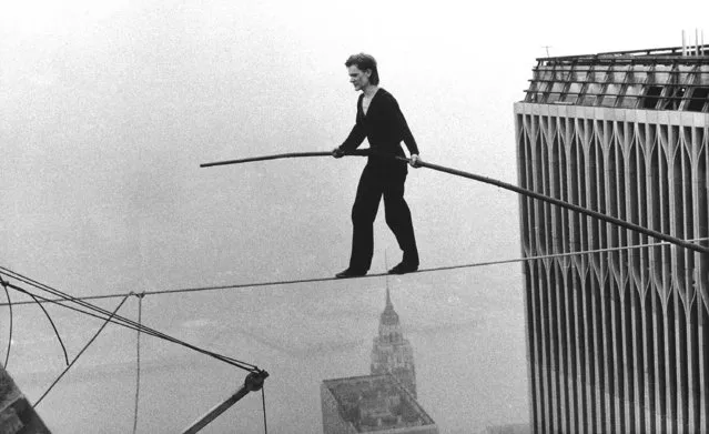 In this August 7, 1974, file photo, Philippe Petit, a French high wire artist, walks across a tightrope suspended between the World Trade Center's Twin Towers in New York. Petit and his companions surreptitiously strung a wire between New York City's recently constructed World Trade Towers on Aug. 6, 1974, and Petit walked across it the next day. He danced, strutted and clowned around for 45 minutes as startled bystanders watched from 110 stories below. The Frenchman's stunt is the subject of the 2008 documentary "Man on Wire" and the 2015 film “The Walk”, starring Joseph Gordon-Levitt. (Photo by Alan Welner/AP Photo)