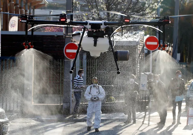 A disinfection squad uses a drone to spray disinfectant in the streets of Cannes in the fight against the spread of the coronavirus disease (COVID-19) in France, April 10, 2020. (Photo by Eric Gaillard/Reuters)