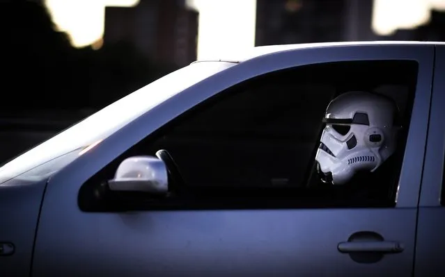 A man drives his car while wearing a Stormtrooper mask from the Star Wars saga, during the fourth week of mandatory quarantine due to the COVID-19 and coronavirus pandemic, in Delta del Tigre, Buenos Aires, Argentina, 14 April 2020. (Photo by Juan Ignacio Roncoroni/EPA/EFE/Rex Features/Shutterstock)