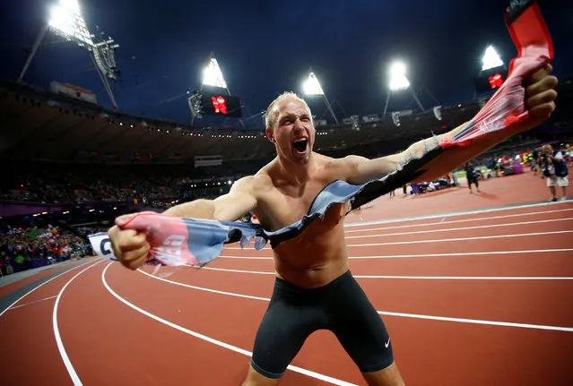 Germany's Robert Harting celebrates after winning the men's discus throw final during the London 2012 Olympic Games at the Olympic Stadium in Britain August 7, 2012. Kai Pfaffenbach: “It was difficult to shoot the picture as Harting played cat and mouse with the few in-field photographers who were allowed to follow him on his honour lap. He did the shirt thing twice before at world championships so none of the photographers wanted to miss the opportunity. I was lucky for a moment before another photographer, who came in too late, ruined everybody else's pictures”. (Photo by Kai Pfaffenbach/Reuters)
