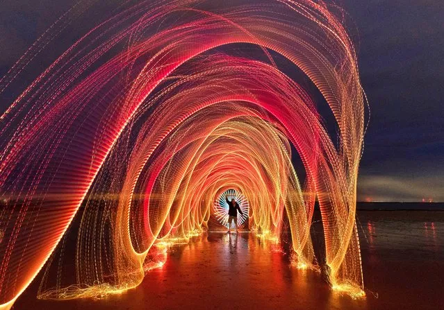 Pictured is light painting on Frinton beach at Frinton-on-Sea in Essex on September 21, 2022. A long exposure of 42 seconds captured the light by the team which were using a fibre optic whip for the tunnel effect along with a cage containing glowing charcoal being swung around on a rope and other light tools. (Photo by Kevin Jay/pictureexclusive.com)