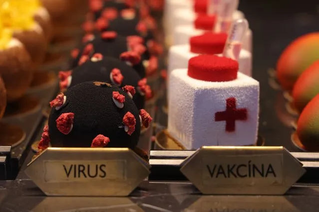Pastries named “virus” and “vaccine” sit on display in the window of a cafe and pastry shop on December 25, 2021 in Prague, Czech Republic. Countries in Central Europe are preparing for what many fear will be a fifth wave of the coronavirus brought on by the rapid spread of the Omicron variant. (Photo by Sean Gallup/Getty Images)