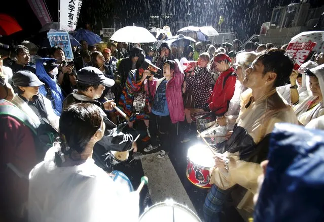 Protesters shouting a chant take part in a rally against Japan's Prime Minister Shinzo Abe's security bill and his administration in front of the parliament in Tokyo, Japan, September 16, 2015. Crowds of protesters rallied on Wednesday as Japan's parliament moved close to passing bills for a defence policy change that could allow troops to fight abroad for the first time since World War Two, despite opposition by many ordinary voters. (Photo by Yuya Shino/Reuters)