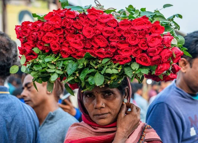 A woman seen selling Rose flowers on the day of Diwali festival at the Ghazipur Wholesale Flower Market on October 24, 2022. (Photo by Pradeep Gaur/SOPA Images/Rex Features/Shutterstock)