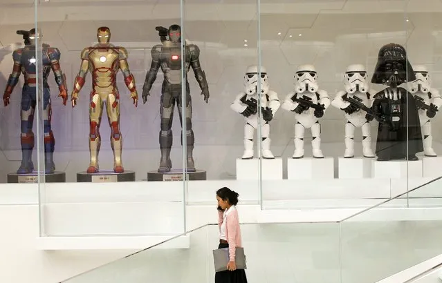 A Thai teen talks on a mobile phone as she walks past figures of characters from US film series Star Wars (R) and fictional superhero Iron Man (L) at a shopping center in Bangkok, Thailand, 25 August 2016. Thailand's economy is forecast to grow between 3.3 to 3.5 percent in 2016 following its gross domestic product growth expanded by 3.5 percent in the second quarter showing positive signs, which mainly boosted by public spending, an increase of activity in the tourism industry and accelerated investment into big infrastructure projects by the government due to political stability after a peaceful referendum. (Photo by Rungroj Yongrit/EPA)