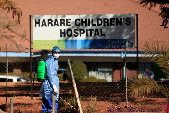 A health worker carries disinfectant equipment outside a hospital during the coronavirus disease (COVID-19) outbreak in Harare, Zimbabwe, July 6, 2020. (Photo by Philimon Bulawayo/Reuters)