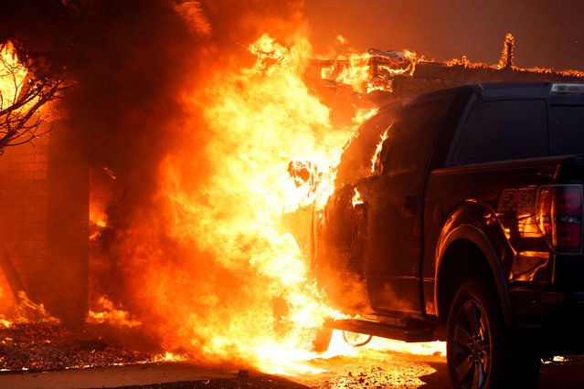 A vehicle burns during a wildfire outbreak in Stillwater, Oklahoma, on March 14, 2025. (Photo by Nick Oxford/Reuters)