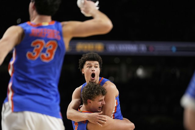 Florida guard Walter Clayton Jr. and center Micah Handlogten celebrate their win against Houston in the NCAA mens' title-game in San Antonio, April 7, 2025. (Photo by Brynn Anderson/AP Photo)