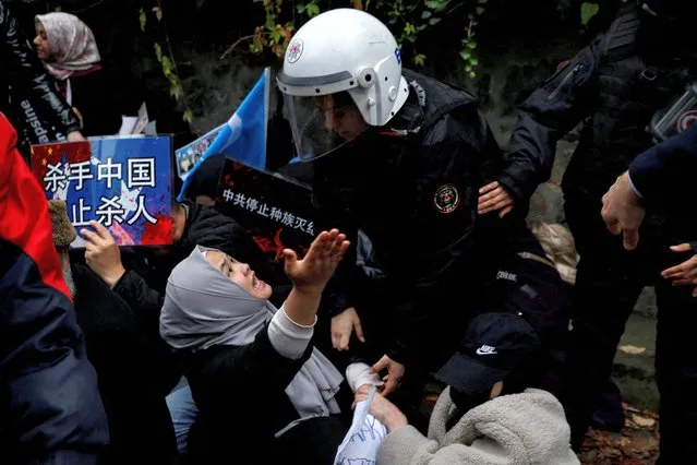 Ethnic Uyghur demonstrators scuffle with riot police as they try to continue a sit-in protest against China, in front of the Chinese consulate in Istanbul, Turkey on November 30, 2022. (Photo by Dilara Senkaya/Reuters)