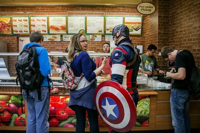 Michael Lambert from Victoria, dressed as Marvel superhero Captain America, waits in line with his wife, Kirsten Bernon, at Subway while taking a break from the last day of the PAX West convention at the Washington State Convention Center on Monday, September 5, 2016, in Seattle, WA, USA. The convention, one of several held across the United States with one also being held in Australia, highlights activity in the gaming industry and features everything from guest panels to competitions and costume contests while also providing a venue for companies to display their new products.  (Photo by Johnny Andrews/The Seattle Times)
