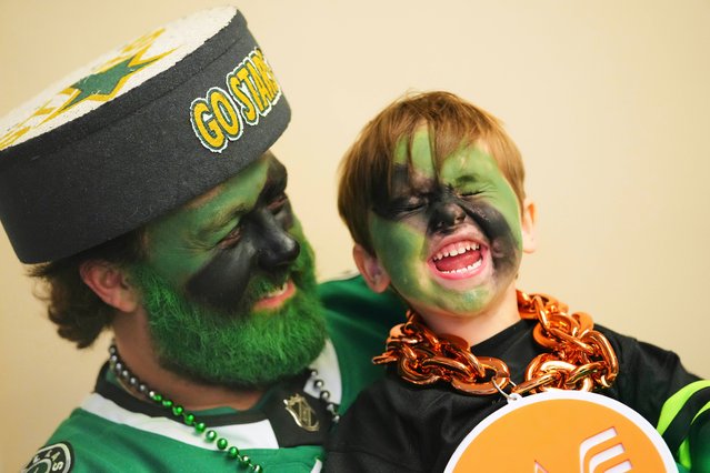 Zane Mathews, left, of Keller, Texas, laughs as he holds his son Hayes, right, in the third period in Game 7 of a first-round NHL hockey playoff series between the Dallas Stars and Colorado Avalanche Saturday, May 3, 2025, in Dallas. (Photo by Julio Cortez/AP Photo)