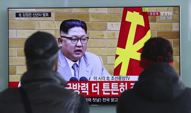 South Koreans watch a TV news program showing North Korean leader Kim Jong Un's New Year's speech, at the Seoul Railway Station in Seoul, South Korea, Monday, January 1, 2018. The letters read on top left, “Kim Jong Un delivers New Year's speech”.  Kim said Monday the United States should be aware that his country's nuclear forces are now a reality, not a threat. But he also struck a conciliatory tone in his New Year's address, wishing success for the Winter Olympics set to begin in the South in February and suggesting the North may send a delegation to participate. (Photo by Lee Jin-man/AP Photo)