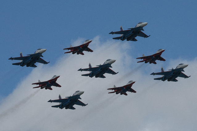 Russia's MiG-29 jet fighters of the Strizhi (Swifts) and Su-30SM jet fighters of the Russkiye Vityazi (Russian Knights) aerobatic teams fly in formation during a military parade on Victory Day on May 9, 2025. (Photo by Shamil Zhumatov/Reuters)