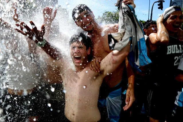 Argentina fans celebrate during the victory parade in Buenos Aires on December 20, 2022. (Photo by Cristina Sille/Reuters)