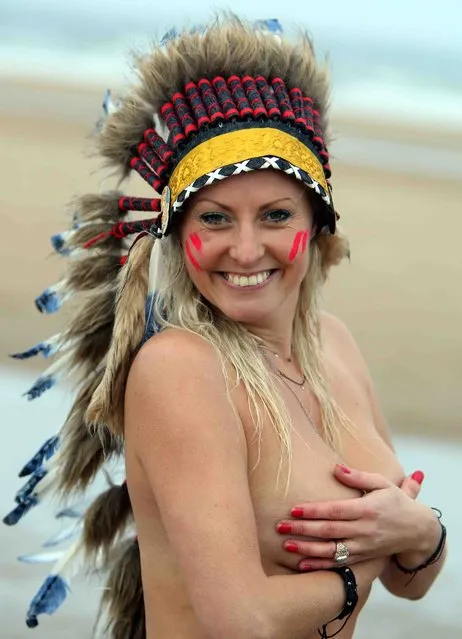 More than 400 people stripped off and ran into freezing waters to celebrate the autumn equinox – and raise money for charity at Druridge Bay, Britain, September 25, 2016. It was the largest turnout the North East Skinny Dip has ever seen in its five-year history, and it was also the first time it has ever rained on the morning of the event. Revellers gathered from 5.30am on Sunday at Druridge Bay, in Northumberland, before baring all in the North Sea. (Photo by David Charlton Photography)