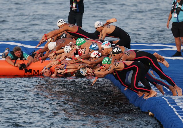Athletes dive into the water at the start of the Open Water Mixed Relay 4x1500m finals during the World Aquatics Championships Singapore 2025 in Singapore, 20 July 2025. (Photo by Fazry Ismail/EPA)