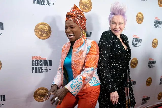 Beninese singer-songwriter Angelique Kidjo (L) and US singer Cyndi Lauper arrive for the Library of Congress Gershwin Prize for Popular Song ceremony in Washington, DC, March 1, 2023. US singer/songwriter Joni Mitchell is this year's winner of the Gershwin Prize. (Photo by Stefani Reynolds/AFP Photo)