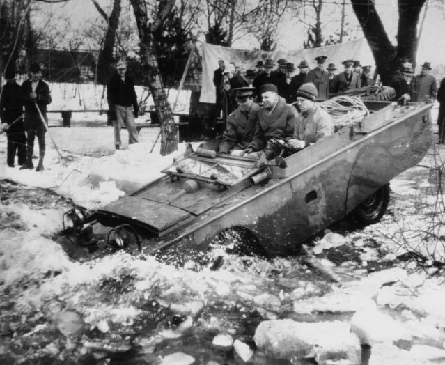 One of the new quarter-ton four-wheel amphibian jeeps, now being produced for U.S. fighting forces, leaves solid ground for a test-run in an ice-clogged stream in the Detroit area on March 23, 1943. (Photo by AP Photo)