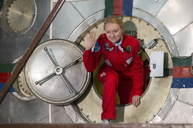 Inna Nosikova exits a mock-up spaceship after an eight-day imitation flight to the moon, in Moscow, Russia, Friday, November 6, 2015. The six-woman crew climbed into a grounded space capsule last week to imitate a lunar flight and test the effects of confinement and stress that come with space travel. While Russia's space medicine center has conducted similar experiments in the past, this is the first time the crew was all female. (Photo by Pavel Golovkin/AP Photo)