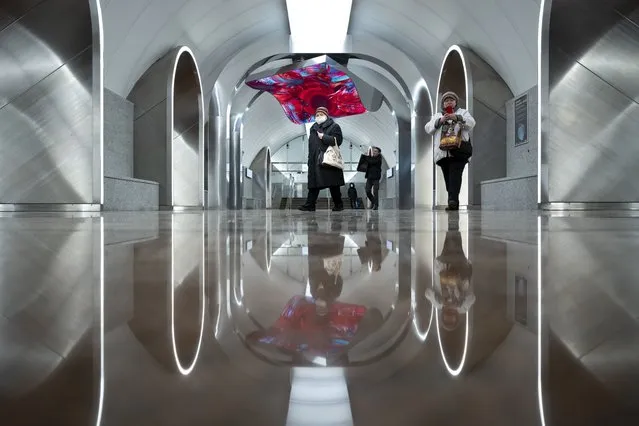 People walk inside the newly opened Rizhskaya (Riga's) station of the Big Circle Line (BCL) of the Moscow Metro (subway) in Moscow, Russia, Monday, March 6, 2023. The new 70 kilometers (43 mile) long Big Circle Line is the longest worldwide, 13 kilometers longer than the previous record holder, the Line 10 of the Beijing Subway. (Photo by Alexander Zemlianichenko/AP Photo)
