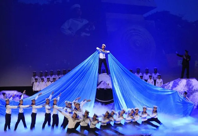 People perform during celebrations to commemorate the 70th anniversary of the establishment of the Vietnam People's Army at the National Convention Center in Hanoi December 20, 2014. (Photo by Reuters/Kham)