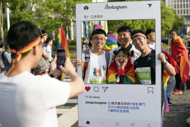 In this April 15, 2018 photo released by Jiangsu Tongtian Volunteer Group, participants pose for photos during a “Rainbow Marathon”, organized months earlier, to raise awareness of LGBT issues in Nanjing in eastern China's Jiangsu province. Weibo.com, one of China's top social networking sites announced Monday, April 16 that it will no longer be censoring content related to gay issues after the plan triggered a loud public outcry. (Photo by Jiangsu Tongtian Volunteer Group via AP Photo)