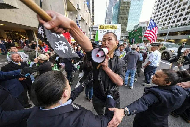 A supporter of Taiwan, center, confronts protesters opposed to Taiwanese independence outside a hotel where Taiwanese President Tsai Ing-wen is expected to arrive in Los Angeles, Tuesday, April 4, 2023. (Photo by Ringo H.W. Chiu/AP Photo)