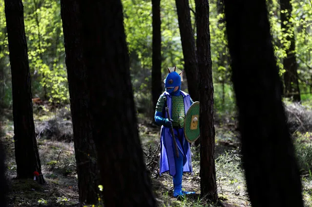 A man dressed as a character from the computer game “World of Warcraft” walks through a forest near the town of Kamyk nad Vltavou, Czech Republic, April 28, 2018. (Photo by David W. Cerny/Reuters)