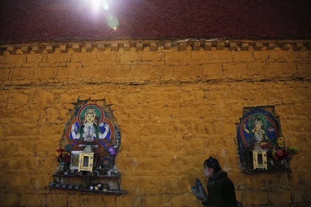 A Tibetan woman prays along walls of the Potala Palace in Lhasa, Tibet Autonomous Region, China November 17, 2015. (Photo by Damir Sagolj/Reuters)