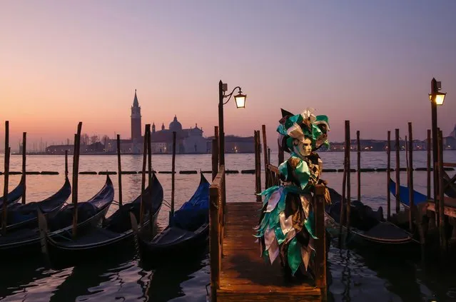 Revellers wearing traditional carnival costumes and masks, along with tourists, flock to Venice for the Venice Carnival on Valentines Day on February 14, 2023. (Photo by Carolyn Jenkins/Alamy Live News)