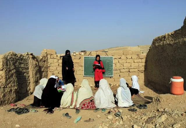 Afghan girls study at an open area, founded by Bangladesh Rural Advancement Committee (BRAC), outside Jalalabad city, Afghanistan September 16, 2015. (Photo by Reuters/Parwiz)