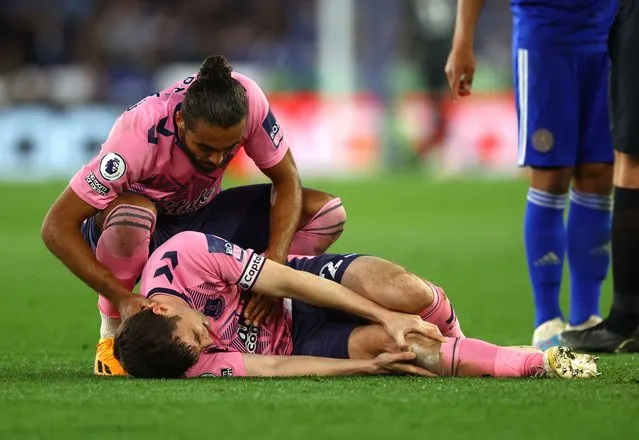 Dominic Calvert-Lewin of Everton comforts team mate Seamus Coleman before he is taken off with a knee injury during the Premier League match between Leicester City and Everton FC at The King Power Stadium on May 1, 2023 in Leicester, United Kingdom. (Photo by Molly Darlington/Reuters)