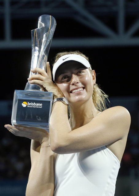 Maria Sharapova of Russia holds the Brisbane International tennis tournament women's singles trophy after defeating Ana Ivanovic of Serbia in Brisbane, January 10, 2015. (Photo by Jason Reed/Reuters)
