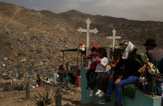 People visit tombs of relatives and friends at “Nueva Esperanza” (New Hope) cemetery during the Day of the Dead celebrations in Villa Maria del Triunfo on the outskirts of Lima, Peru, November 1, 2016. (Photo by Mariana Bazo/Reuters)