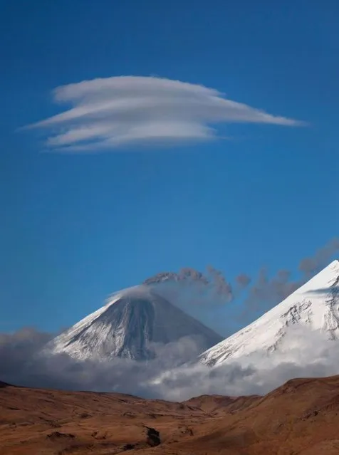 Lenticular clouds hover of the mountains of the Kamchatka Peninsula in Russia. (Photo by Denis Budkov/Caters News)