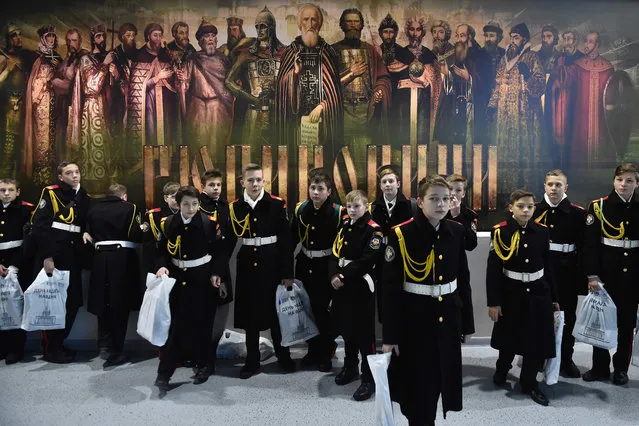 Military cadets gather in front of a huge poster depicting members of the Rurik dynasty during a mass lesson at Moscow' s VDNH (the Exhibition of Achievements of National Economy) exhibition centre on November 16, 2016. (Photo by Natalia Kolesnikova/AFP Photo)