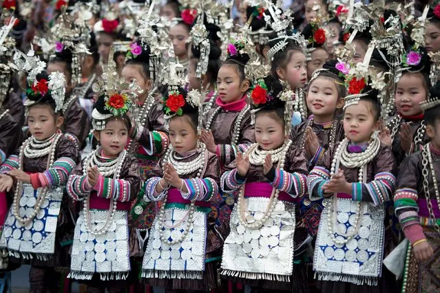 Ethnic Dong children wearing traditional costumes clap as they participate in a singing contest in Rongjiang, Guizhou province, December 18, 2015. (Photo by Reuters/Stringer)