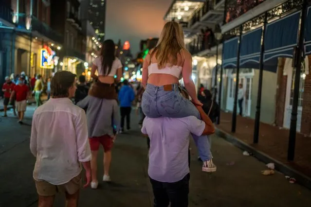 People wander Bourbon Street as the coronavirus disease (COVID-19) restrictions are eased in New Orleans, Louisiana, U.S., March 14, 2021. (Photo by Kathleen Flynn/Reuters)